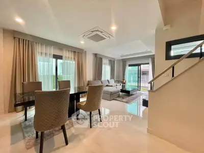 Spacious modern living room with elegant dining area and large windows