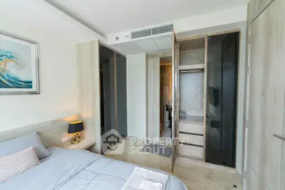 Modern bedroom with built-in wardrobe and stylish decor in a contemporary apartment.