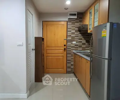 Modern kitchen with wooden cabinets and stainless steel appliances in cozy apartment