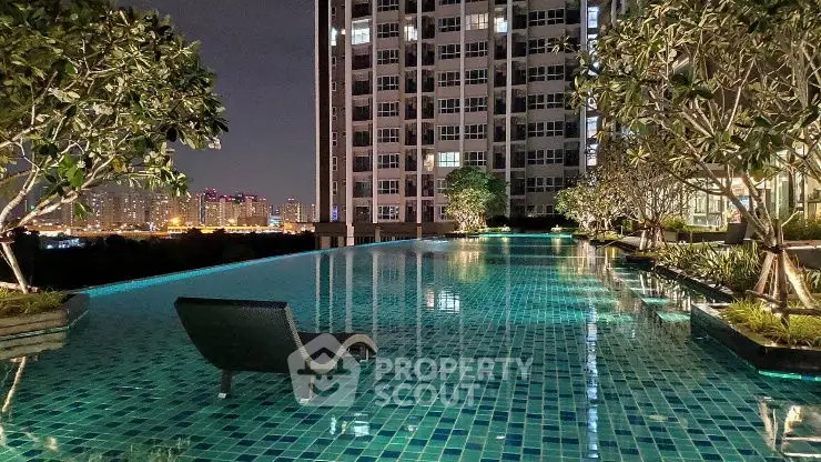 Luxurious high-rise apartment with stunning night pool view and cityscape.