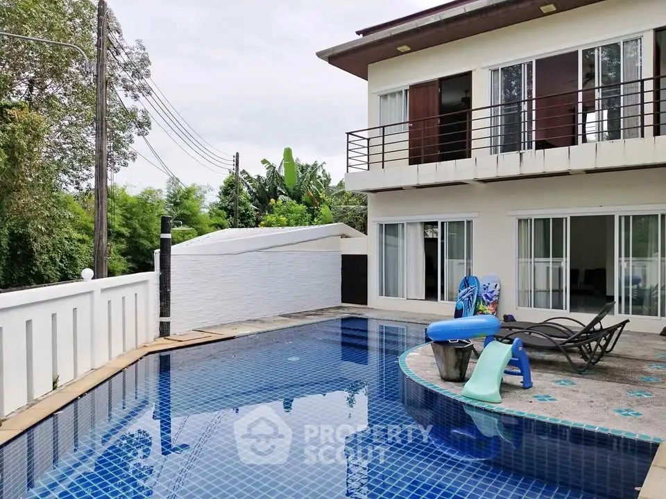 Modern villa with private pool and spacious balcony in lush green setting.