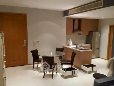 Modern kitchen and dining area with sleek design and stainless steel appliances.