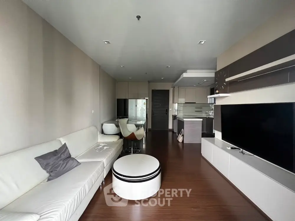 Modern living room with sleek furniture and open kitchen layout
