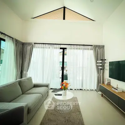 Spacious living room with high ceiling and modern decor