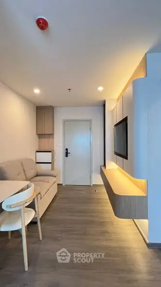 Modern living room with sleek furniture and ambient lighting, perfect for cozy relaxation.