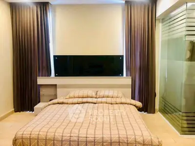 Spacious bedroom with modern design and large windows for natural light.