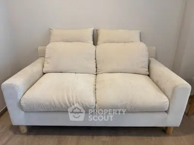 Cozy beige sofa in a modern living room setting, perfect for relaxation and comfort.