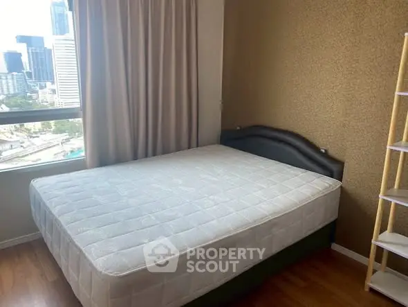 Cozy bedroom with city view, featuring a comfortable bed and elegant decor, perfect for urban living.