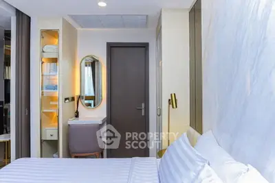 Modern bedroom with elegant decor and cozy ambiance, featuring a stylish desk and comfortable bedding.