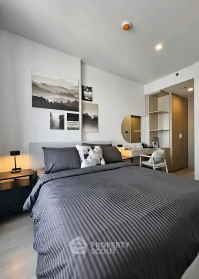 Modern bedroom with stylish decor and ample storage in a contemporary apartment.