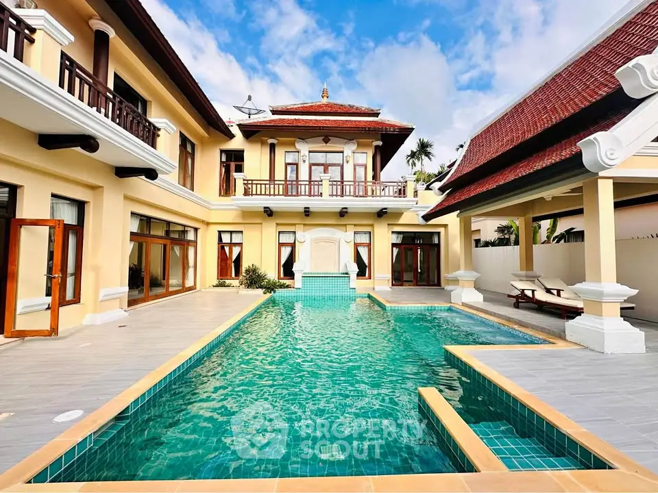 Luxurious villa with stunning pool and elegant architecture under blue sky.