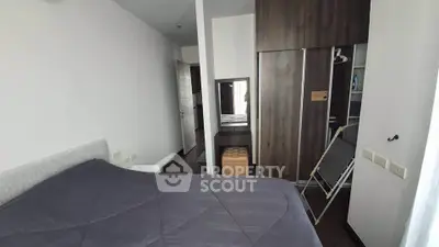 Modern bedroom with sleek wardrobe and cozy bed in stylish apartment.