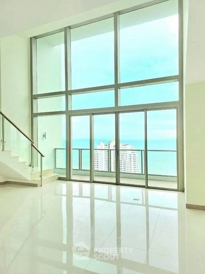 Stunning high-rise apartment with floor-to-ceiling windows and ocean view.