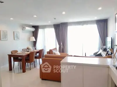 Spacious living room with elegant dining area and natural light