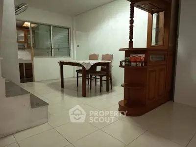 Cozy dining area with wooden furniture and open kitchen layout, perfect for family gatherings.