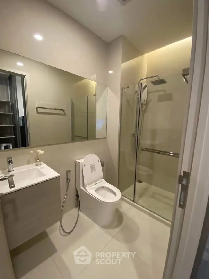 Modern bathroom with sleek fixtures and glass shower enclosure