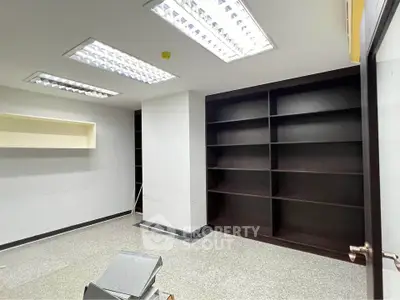 Spacious study room with built-in shelves and modern lighting