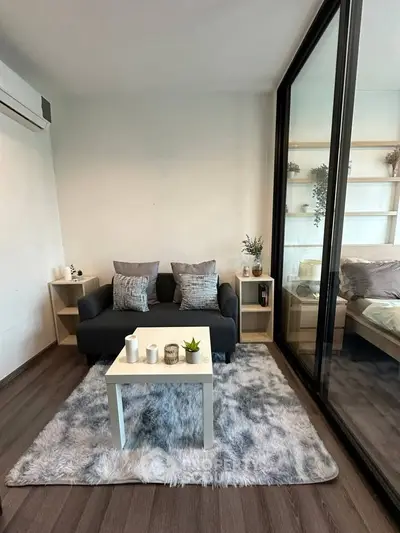 Cozy living room with modern decor and plush rug, perfect for relaxation.