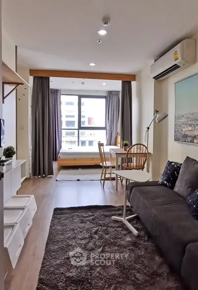 Modern studio apartment with cozy living area and large window view