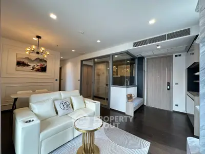 Luxurious modern living room with elegant decor and open layout, featuring a cozy seating area and stylish dining space.