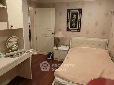 Cozy bedroom with elegant decor and soft lighting, featuring a comfortable bed and stylish vanity.
