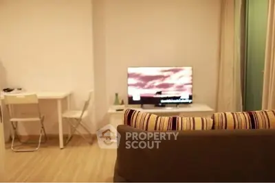 Cozy living room with modern decor and flat-screen TV