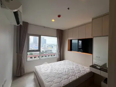 Modern bedroom with city view, featuring built-in storage and large windows for natural light.