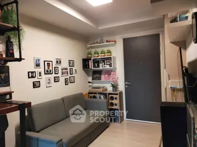 Cozy living room with modern decor and wall art, featuring a comfortable sofa and stylish shelving.