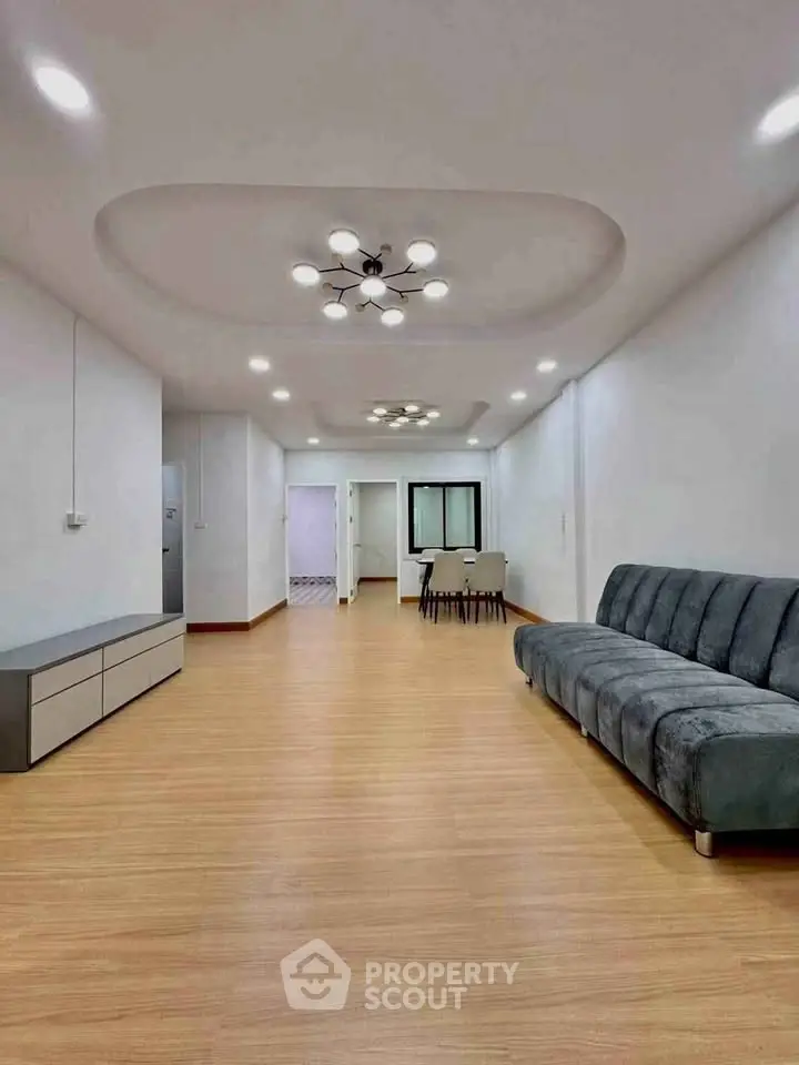Spacious modern living room with elegant lighting and stylish furniture