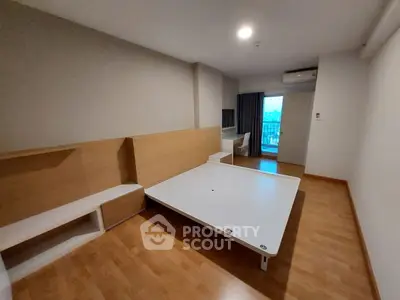 Modern minimalist bedroom with wooden flooring and large window view