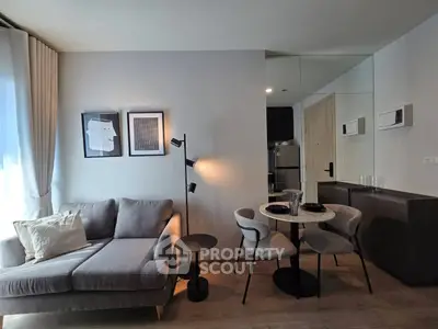 Modern living room with stylish decor and dining area in open layout apartment.
