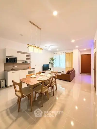 Spacious open-plan living and dining area with modern furnishings and ample natural light.