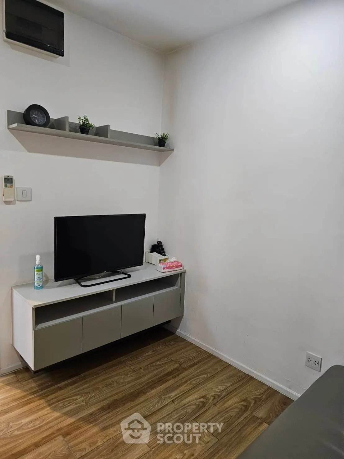 Cozy living room with modern TV setup and wooden flooring