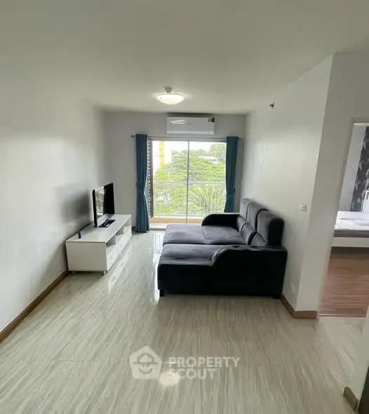 Modern living room with sleek furniture and large window view