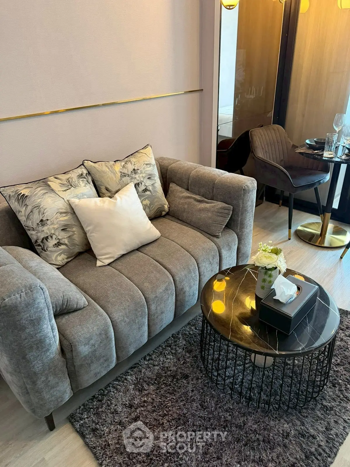 Stylish living room with plush sofa and elegant decor in modern apartment.