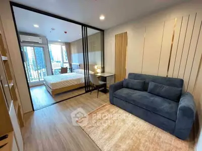 Modern studio apartment with glass partition, cozy living area, and city view balcony.
