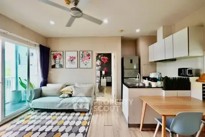 Modern open-plan living room and kitchen with stylish decor and balcony access