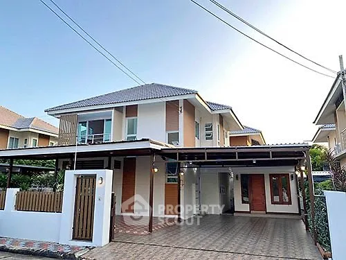 Modern two-story house with spacious driveway and contemporary design