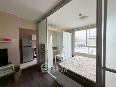 Modern bedroom with sliding glass doors and natural light