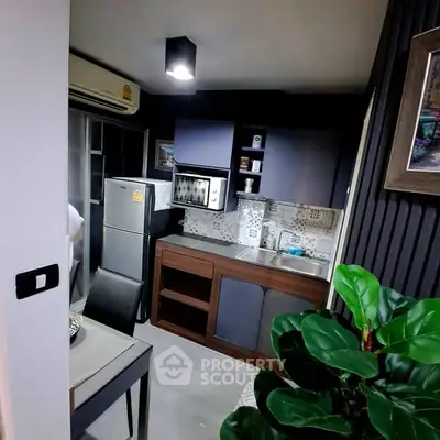 Modern compact kitchen with sleek cabinets and stainless steel appliances