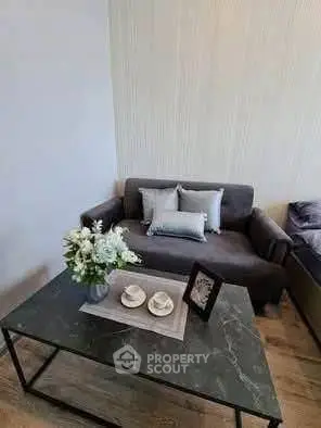 Modern living room with stylish sofa and elegant coffee table in a cozy apartment.