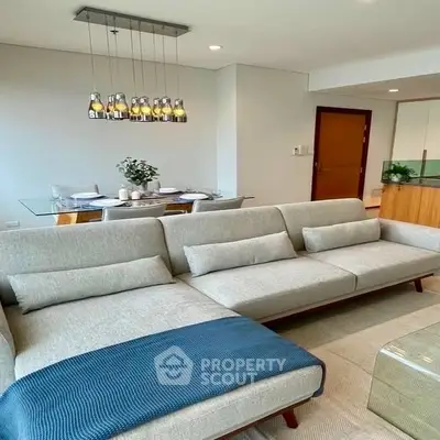 Modern living room with stylish sofa and elegant dining area