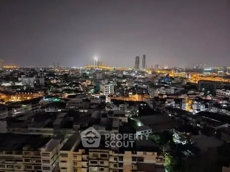 Stunning cityscape view showcasing vibrant urban skyline at night with illuminated buildings.