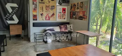 Trendy cafe interior with artistic posters and garden view