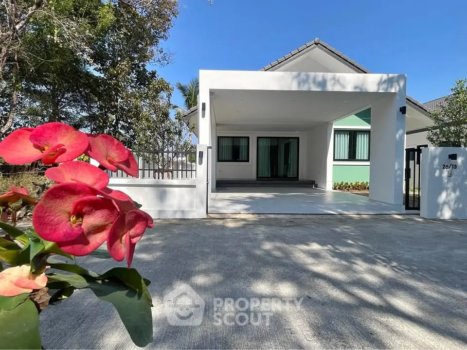 Charming modern house with spacious driveway and lush garden view