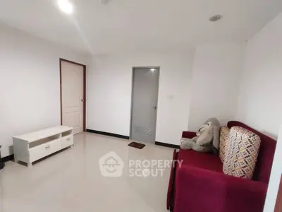 Spacious living room with modern decor and plush seating in a minimalist style apartment.