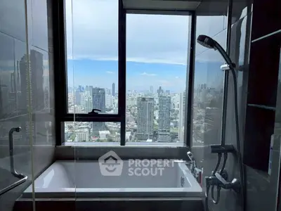 Luxurious bathroom with city skyline view from bathtub window.