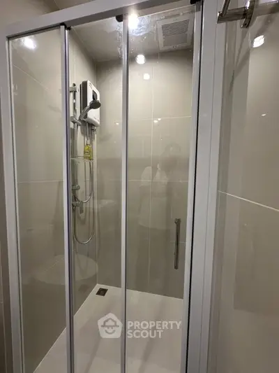 Modern bathroom with glass shower enclosure and sleek fixtures