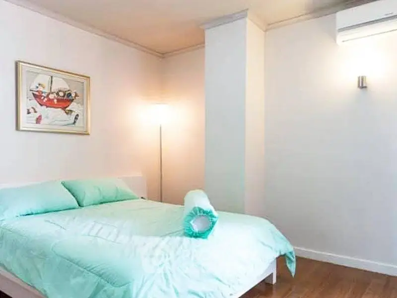 Cozy bedroom with modern decor and soft lighting, perfect for relaxation.