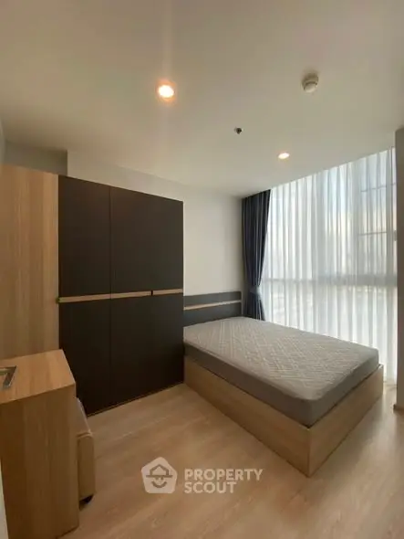 Modern bedroom with large window and minimalist design